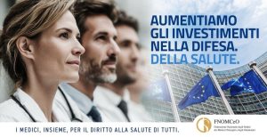 Medici e operatori sanitari con bandiere europee e messaggio sulla necessità di investire nella sanità pubblica