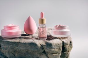 Prodotti per la skincare come sieri, creme e cosmetici esposti su una superficie, rappresentativi delle routine di bellezza diffuse sui social.